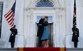 US President Joe Biden hugs First Lady Jill Biden as they arrive at the White House.