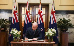 The Prime Minister signing Jim Bolger's condolence book