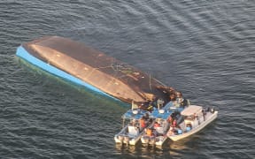 An aerial image shows the capsized ferry MV Nyerere
