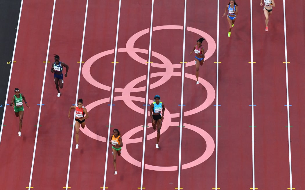 Ivory Coast's Marie-Josee Ta Lou (4ths L) wins the women's 200m semi-final during the Tokyo 2020 Olympic Games at the Olympic stadium in Tokyo on August 2, 2021. (Photo by Antonin THUILLIER / AFP)