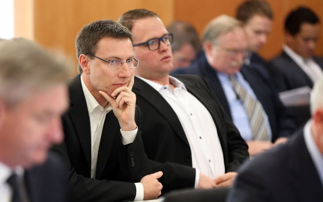 Megaupload executives Mathias Ortmann (L) and Bram van der Kolk (R) are seen in court during an extradition hearing in Auckland on September 24, 2015. Internet mogul Kim Dotcom's long-awaited extradition hearing opened in New Zealand September 24 with the flamboyant founder of now-defunct Megaupload confident he can avoid being sent to the United States to face online piracy charges. Dotcom and three others - Mathias Ortmann, Bram van der Kolk and Finn Batato - were arrested on charges of criminal copyright violation back in 2012. AFP PHOTO / Michael Bradley (Photo by MICHAEL BRADLEY / AFP)