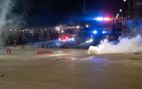 Detroit police in riot gear and an armoured vehicle wait in formation as people were protesting the killing of George Floyd.