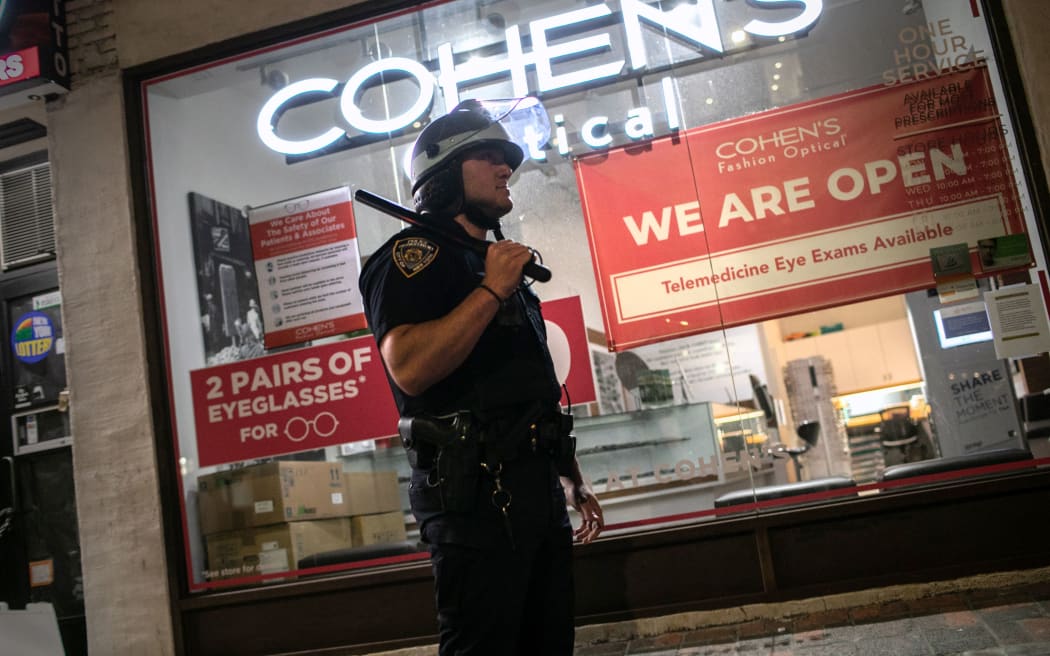 A New York City policeman stands guard on Broadway during a night of protests and vandalism over the death of George Floyd on June 1, 2020 in New York City.