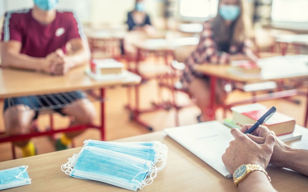 View from the teachers desk of students wearing protective masks against coronavirus disease.