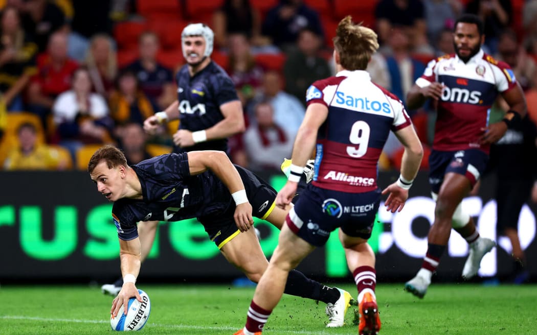 Ruben Love scores a try during the Reds v Hurricanes, Super Rugby Pacific match, Suncorp Stadium, Brisbane.