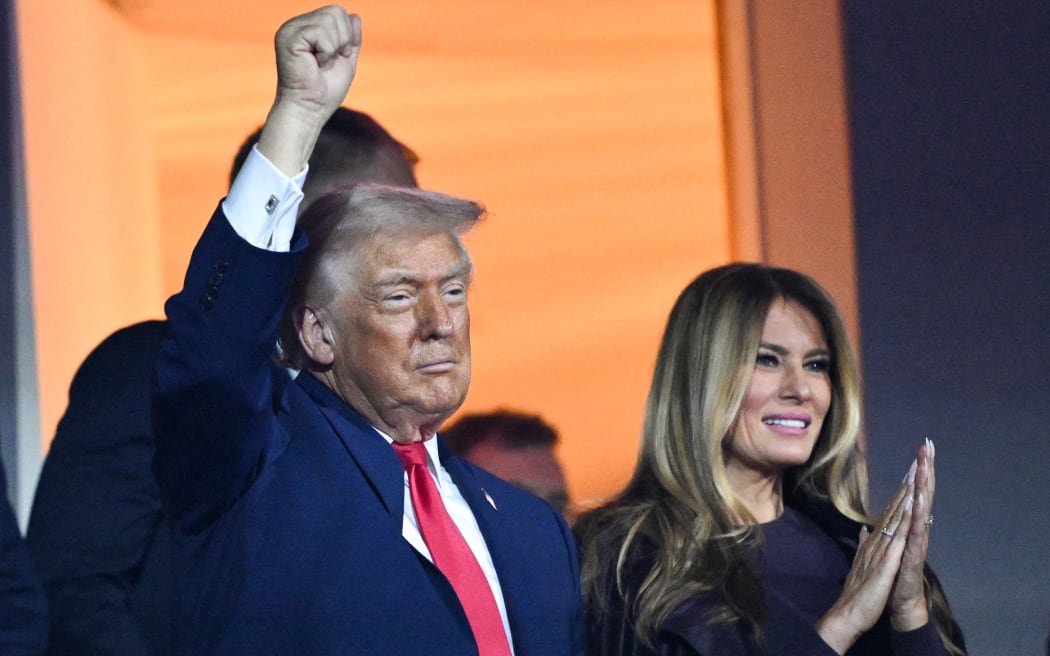 US President Donald Trump (L) gestures alongside US First Lady Melania Trump during the draw for the 2026 FIFA Football World Cup taking place in the US, Canada and Mexico, at the Kennedy Center, in Washington, DC, on December 5, 2025. (Photo by Mandel NGAN / POOL / AFP)