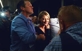 Australian television presenter Tara Brown (C) walks through a media scrum in Sydney airport on April 21, 2016, after she and her crew were released on bail from prison in Beruit.
