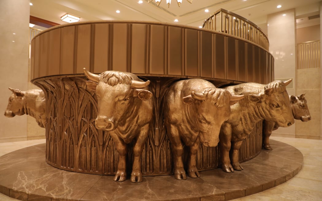 Twelve golden oxen hold the baptismal font up.