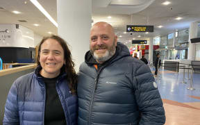 Auckland International Airport - flights canned due to Cyclone Gabrielle - Carlos Masino and his wife Carolina