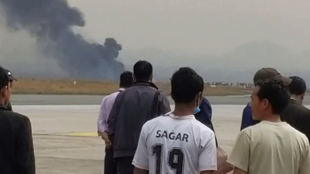 This screengrab of video footage from the Facebook account of Nitin Keyal shows smoke rising from the site of the crash.