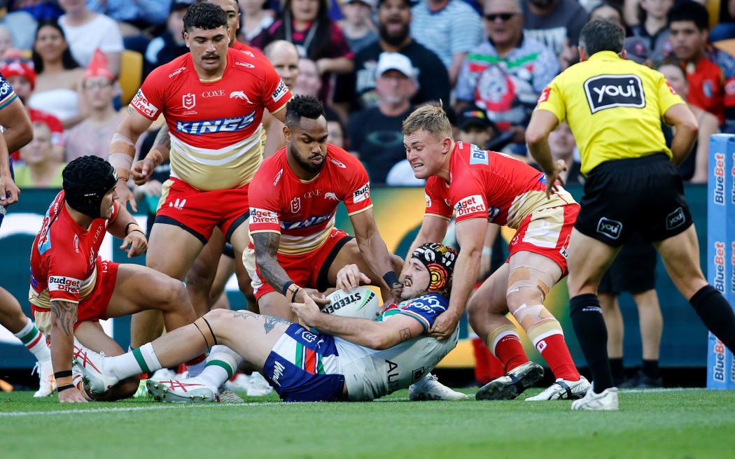 Warriors forward Josh Curran is surrounded by Dolphins defenders.