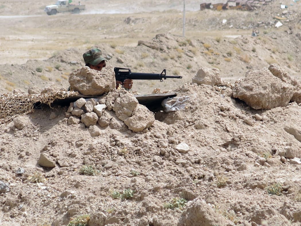 A fighter from a Shiite paramilitary units, known as Hashd Shaabi, takes position.
