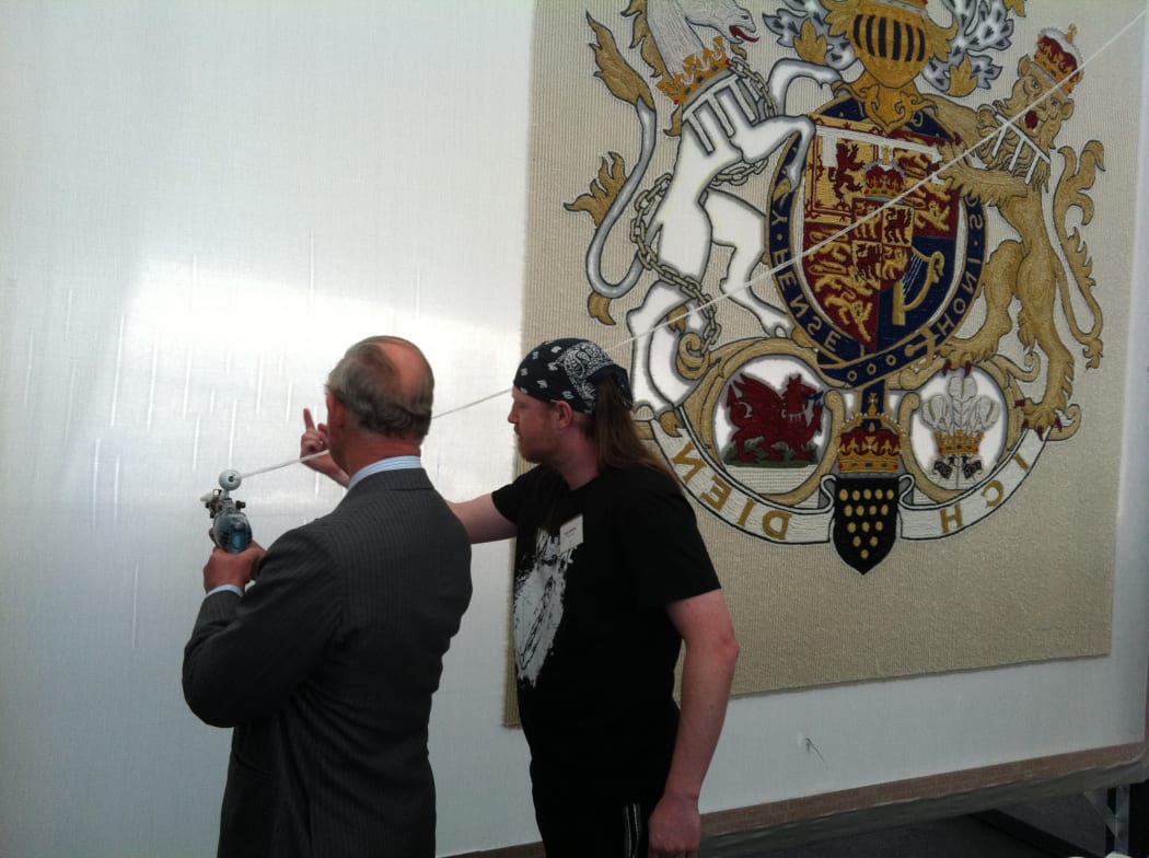 Prince Charles, in his New Zealand wool suit, has a go at Sam Maloney's wool gun.