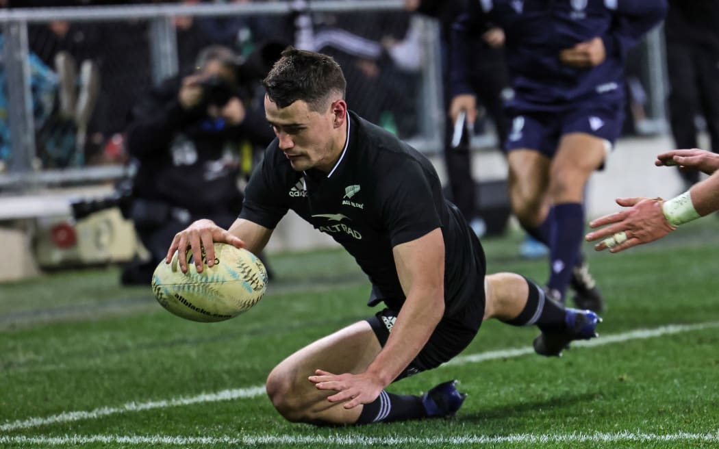 Will Jordan of New Zealand scores a try.