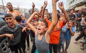 Palestinian children celebrate in Khan Yunis on 9 October, 2025, following news of a new Gaza ceasefire deal.
