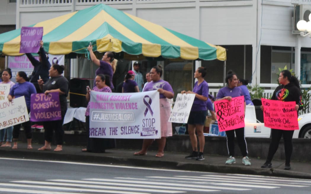 Supporters line the road in downtown Fagatogo during a rally against domestic violence