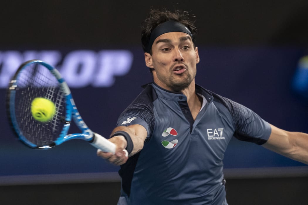 John Isner of the US hits a return against Fabio Fognini of Italy during their tenth session men's singles match on day five of the ATP Cup tennis tournament in Perth on January 7, 2020.