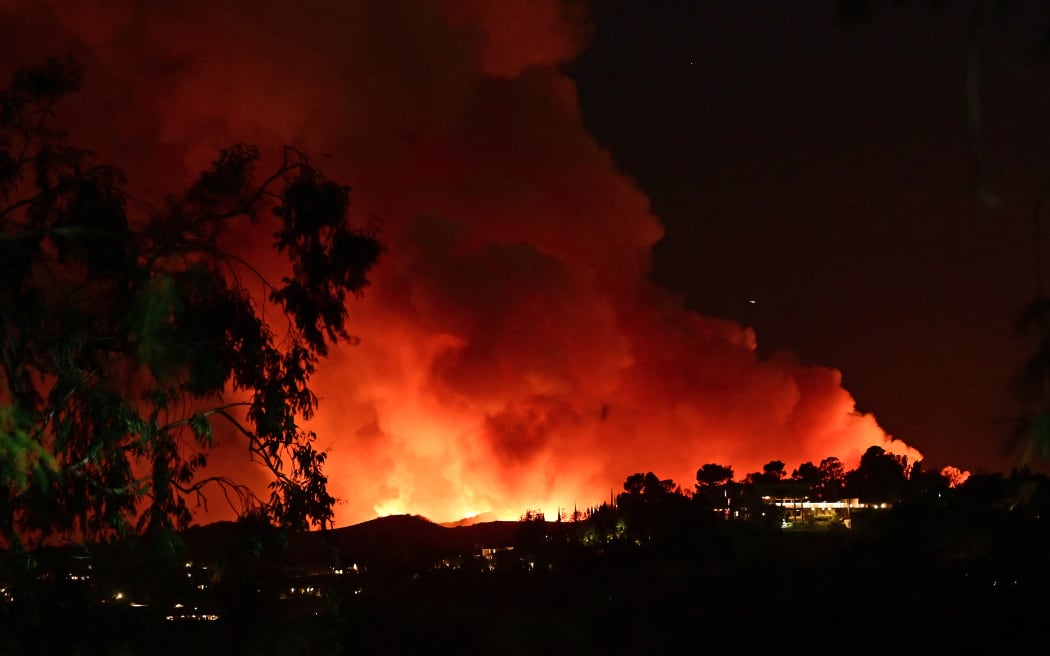 Smoke and flames from the Palisades Fire burn toward the Encino neighborhood of Los Angeles, California, January 10, 2025, triggering new evacuation orders. Massive wildfires that engulfed whole neighborhoods and displaced thousands in Los Angeles have killed at least 10 people, authorities said, as California's National Guard soldiers readied to hit the streets to help quell disorder.
News of the growing toll, announced late Thursday January 9 by the Los Angeles County Medical Examiner, came as swaths of the United States' second-largest city lay in ruins. (Photo by AGUSTIN PAULLIER / AFP)