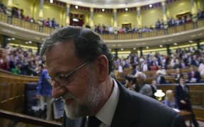Spain's out-going Prime Minister Mariano Rajoy leaves after a vote on a no-confidence motion at the Lower House of the Spanish Parliament in Madrid on June 01, 2018.