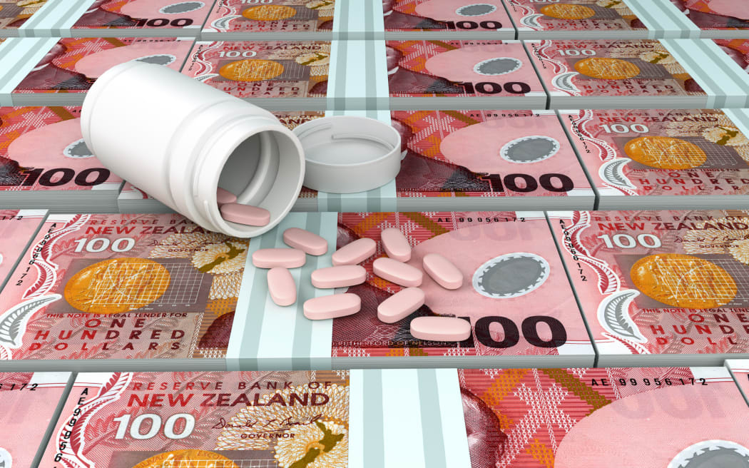 Medicine dose on piles of New Zealand Currency