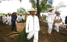 Descendants of the first Chinese workers re-enacted their path along Atimaono beach, Tahiti, on Sunday.