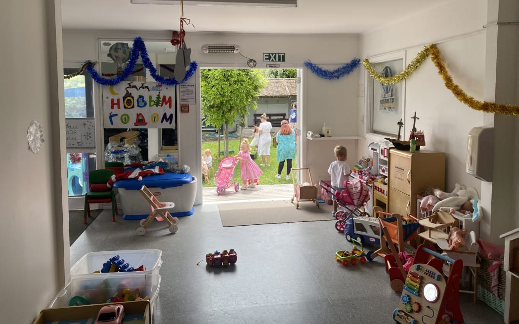 Picture of a children's space. Decorations hang on walls and there are many toy options.