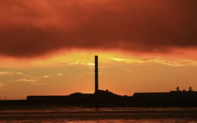 21586193 - a vibrant sunrise overlooking bluff aluminium smelter new zealand