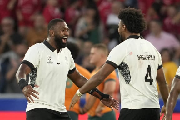 Fiji's Isoa Nasilasila, right, and Temo Mayanavanua celebrate victory over Australia in their Rugby World Cup Pool C match in Saint-Etienne, south-eastern France on 17 September 2023.