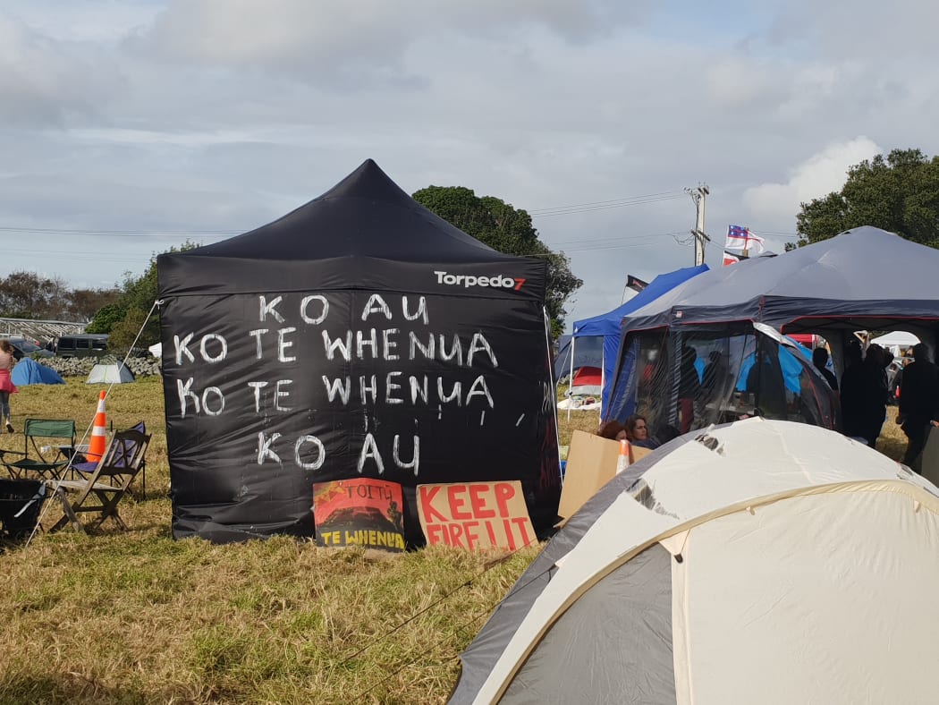 "I am the whenua, the whenua is me": Many campers have decorated their tents with whakataukī.