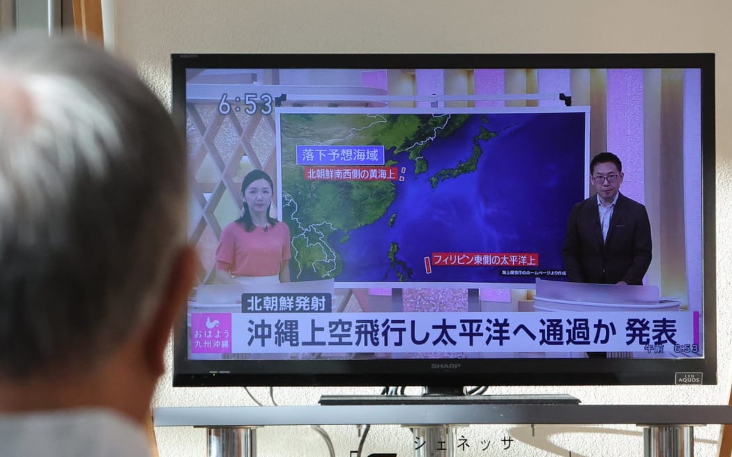 A man watches a news on North Korea at the Naha Airport in Naha City, Okinawa Prefecture on Aug. 24, 2023. The government announced that a possible ballistic missile was launched from North Korea. The missile was believed to have passed into the Pacific Ocean. North Korea said that their second spy satellite launch failed and will try again in October. ( The Yomiuri Shimbun ) (Photo by Daisuke Urakami / Yomiuri / The Yomiuri Shimbun via AFP)