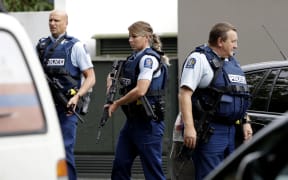 Armed police patrol outside a mosque in central Christchurch, New Zealand, Friday, March 15, 2019. A witness says many people have been killed in a mass shooting at a mosque in the New Zealand city of Christchurch. (AP Photo/Mark Baker)