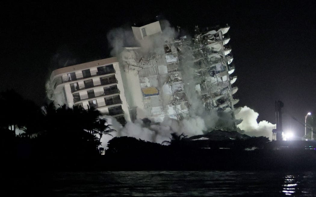 The remaining part of the partially collapsed 12-story Champlain Towers South condo building fell in a controlled demolition on July 4, 2021 in Surfside, Florida