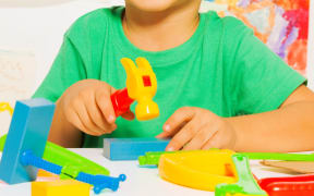 A boy plays with a toy hammer in a primary school classroom (file photo)