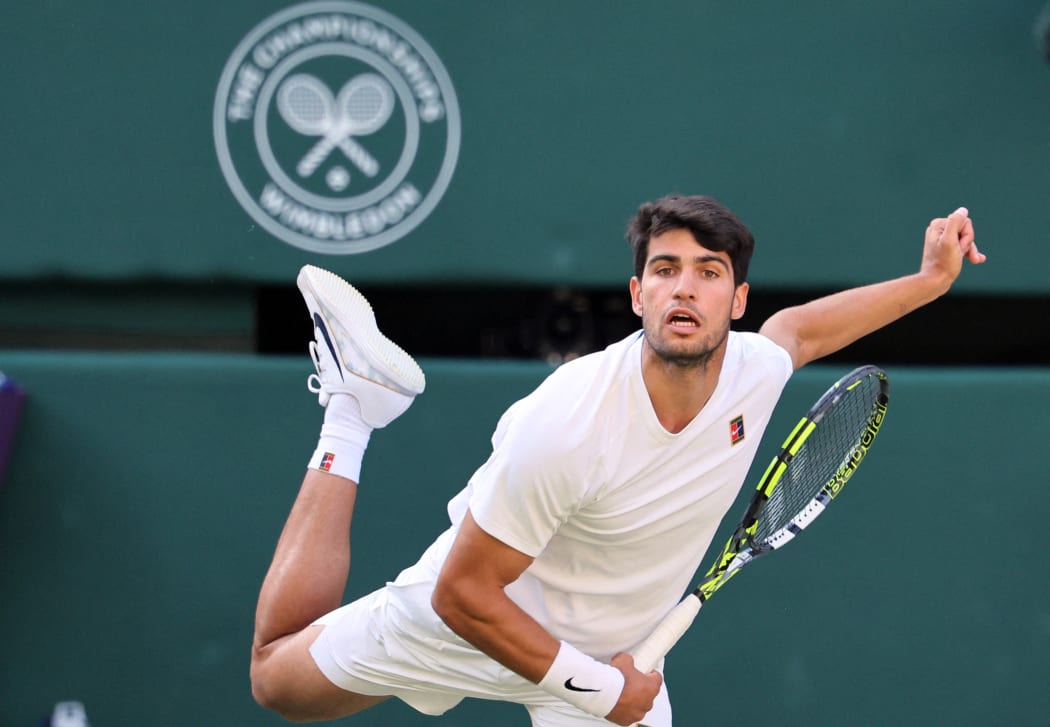 Carlos Alcaraz of Spain serves a ball to Cameron Norrie of United Kingdom during their men's singles quarter-finals match on day nine of the Wimbledon Championships at the All England Lawn Tennis and Croquet Club in London, July 8, 2025. ( The Yomiuri Shimbun ) (Photo by Daisuke Urakami / The Yomiuri Shimbun via AFP)