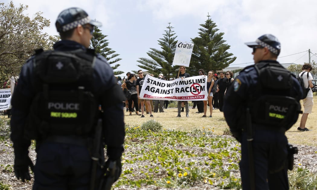 Police look on at anti-racism protestors against the 10th anniversary of the Cronulla riots rally, at the Don Lucas reserve in Cronulla, Sydney.
