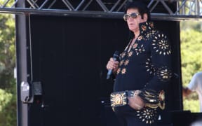Elvis tribute artist Kerryn Winn performing at Elvis in the Gardens .