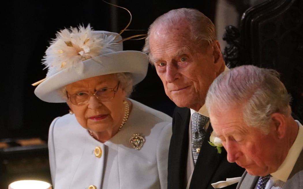 Britain's Queen Elizabeth II (L), Britain's Prince Philip, Duke of Edinburgh (C) and Britain's Prince Charles, Prince of Wales attend the wedding ceremony of Britain's Princess Eugenie of York (C) and Jack Brooksbank at St George's Chapel, Windsor Castle, in Windsor, on October 12, 2018.