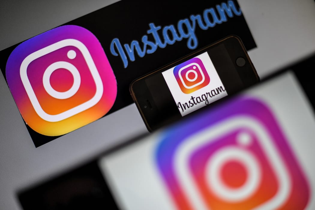 Logo of social network Instagram are displayed on the screen of a smartphone.