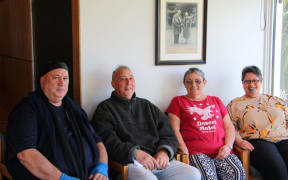 Rangiora musician Bobby Thompson-Browne, Tuahiwi kaumātua Tira-Roa Reuben and Tawhai Kimura, and Tuahiwi local Liz Kereru sitting underneath a photo of former Labour MP for Southern Māori, Eruera Tirikātene at Tuahiwi marae.