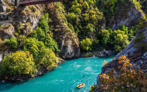 Journey to the South Island of New Zealand. A picturesque river in a mountain gorge. Attraction Bungee jumping on a bridge over a mountain river.