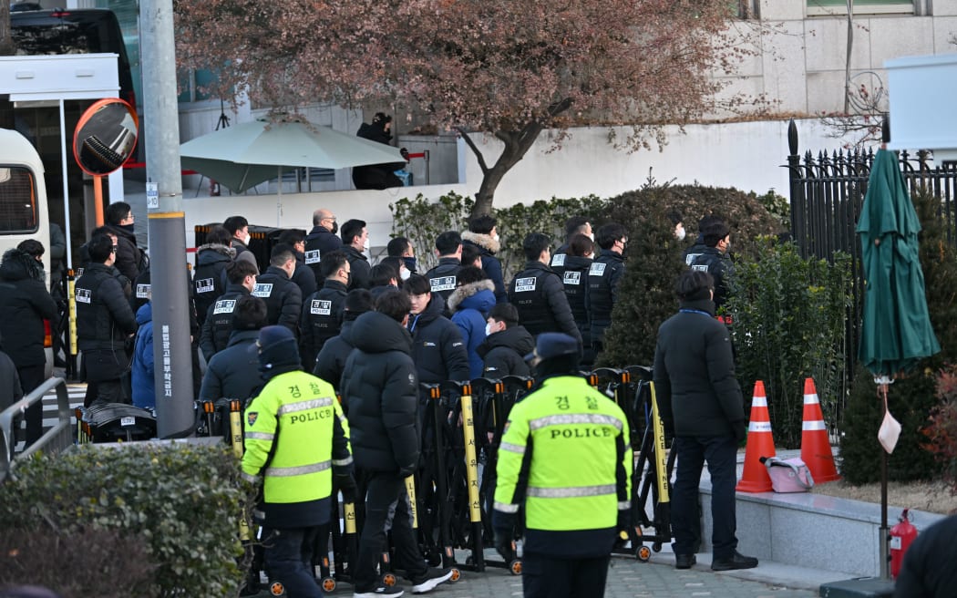 Police and anti-corruption investigators arrive at the residence of South Korea's impeached President Yoon Suk Yeol in Seoul on January 3, 2025. - South Korean investigators arrived outside the presidential residence early Friday seeking to arrest Yoon Suk Yeol, with the impeached leader's die-hard supporters massing outside to protect him, AFP reporters saw. Cars carrying investigators probing Yoon's short-lived declaration of martial law drove up to his residence in central Seoul, which was surrounded by a heavy police presence, AFP saw. Yoon would become the first sitting president in South Korean history to be arrested. (Photo by JUNG Yeon-je / AFP)