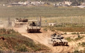 Israeli tanks move in an area along the border with the Gaza Strip and southern Israel on 4 April, 2024, amid the ongoing conflict in the Palestinian territory between Israel and the militant group Hamas.