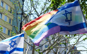 01 June 2019, Berlin: Israeli flags and the rainbow flag blow in the wind during a pro-Israel demonstration.