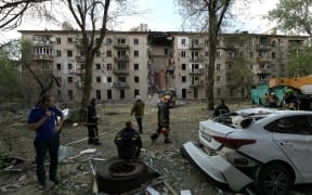 Rescuers work at the site of a missile attack in Luhansk, Russian-controlled Ukraine, on 7 June, 2024, amid ongoing Russian-Ukrainian conflict. A Ukrainian missile strike on the Russian-controlled city of Luhansk on June 7, 2024 ripped through a block of flats, killing four and injuring over 40, Russia-appointed officials said.