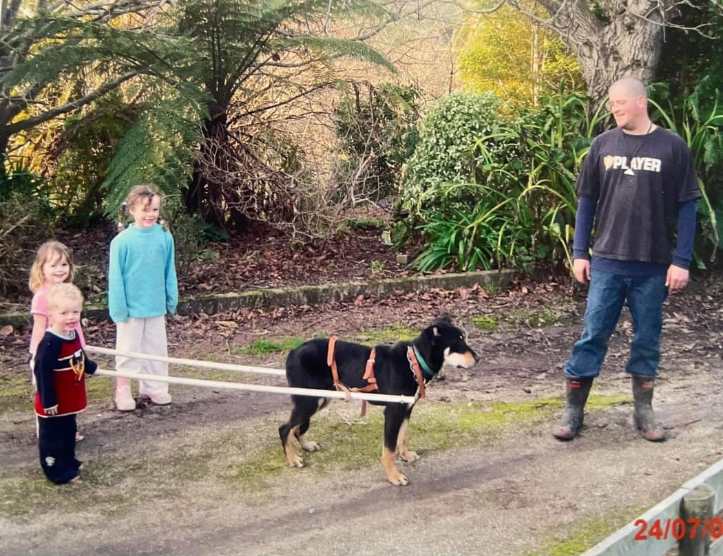 Clark Chrystal with his three children training their dog Hendrix