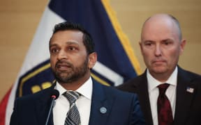 FBI director Kash Patel (L), speaks as Utah Governor Spencer Cox looks on during a press conference outside the Doterra Auditorium at Utah Valley University two days after youth activist and influencer Charlie Kirk was shot during a public event in Orem, Utah, on September 12, 2025. US President Donald Trump on Friday announced that the suspect had been taken into custody over the killing of right-wing activist Charlie Kirk after a massive manhunt. (Photo by Patrick T. Fallon / AFP)