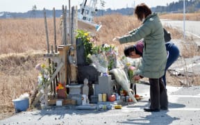 A couple at a shrine near the stricken nuclear plant on the third anniversary of the disaster.