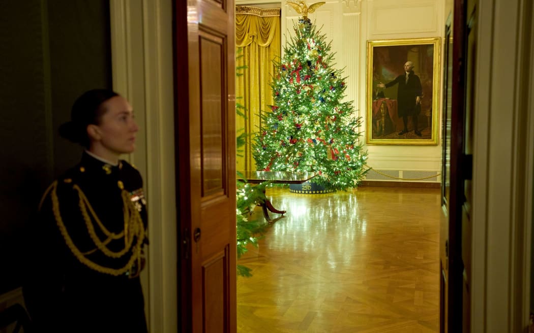 Christmas trees decorate the East Room of the White House on Monday, 1 December 2025.