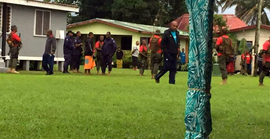 Ratu Epenisa Cakobau escorted by Police and armed military personnel.