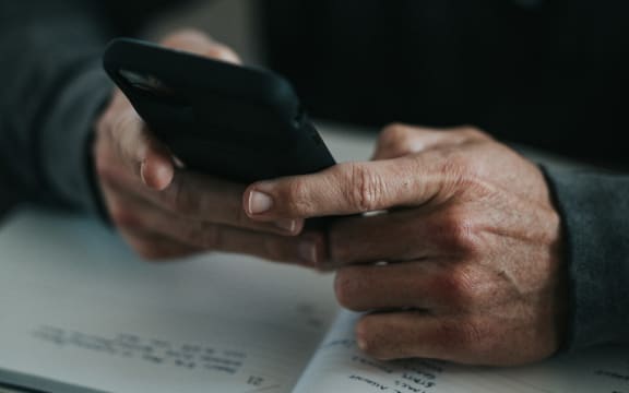 A man uses a cell phone.